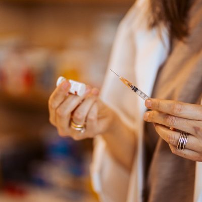 Close up of the syringe for the covid 19 vaccine in the hands of a healthcare woman